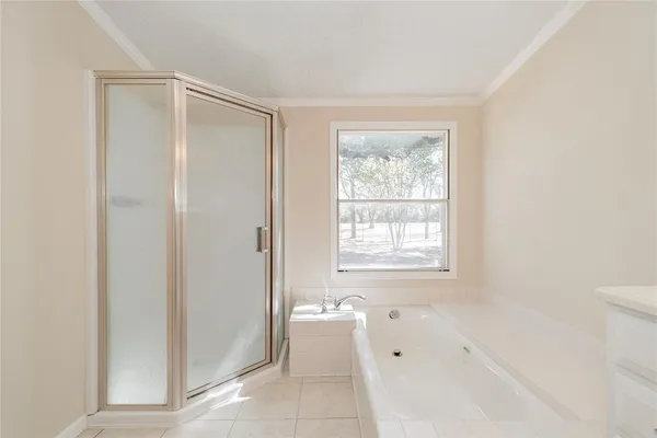 a spacious bathroom with a bathtub and shower