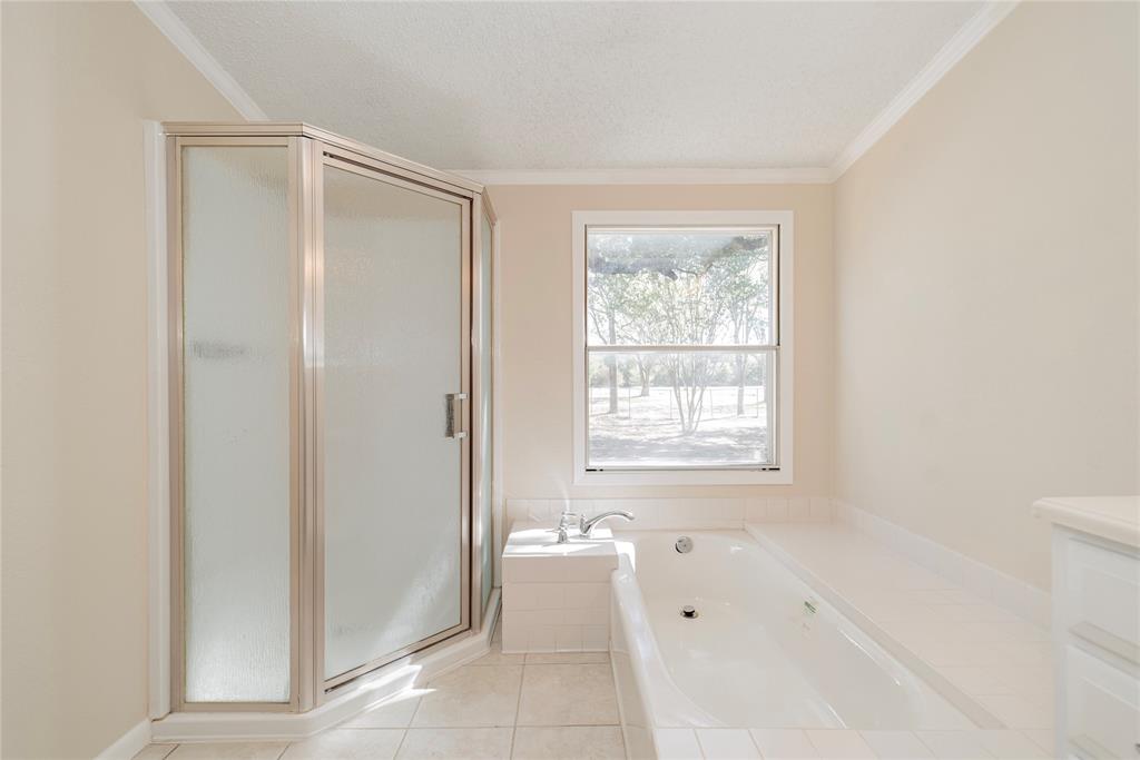 667 Rs County Road 1503 Point, TX 75472 - Photo 27 of 38 a spacious bathroom with a bathtub and shower