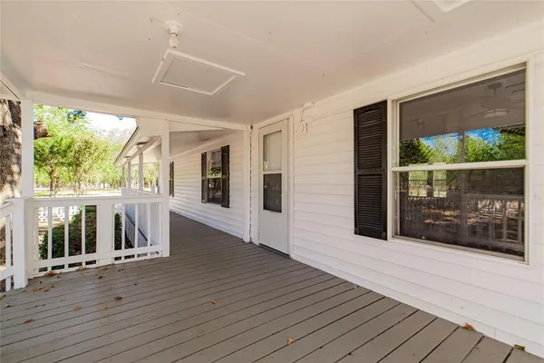 a view of a porch with wooden floor and outdoor space