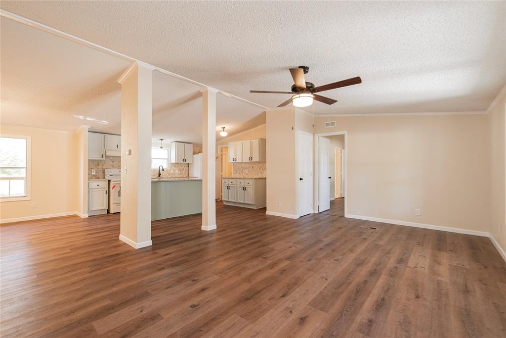 667 Rs County Road 1503 Point, TX 75472 - Photo 3 of 38 a view of a kitchen with wooden floor and a ceiling fan