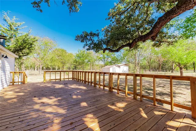 a view of balcony with wooden floor and fence