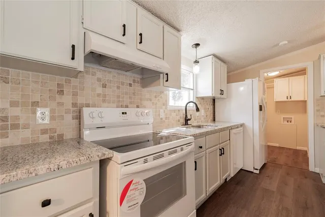 a kitchen with a sink stove and cabinets