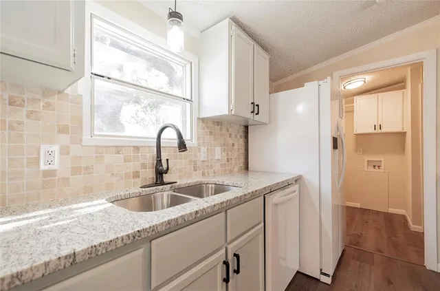 a kitchen with a sink and cabinets