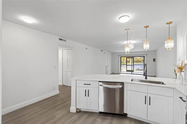 a kitchen with a sink cabinets and window