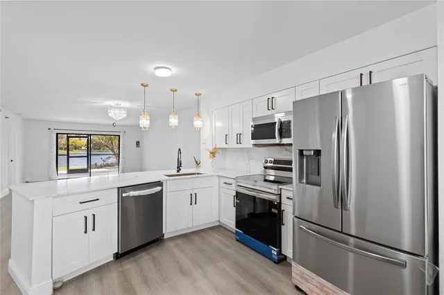 a kitchen with a refrigerator sink and dishwasher