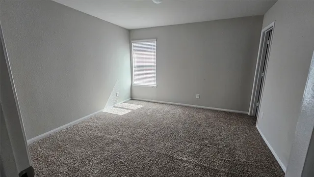 an empty room with a empty space and a window