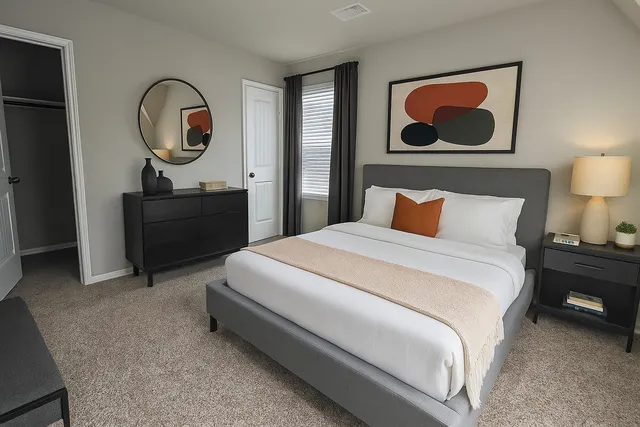 a bedroom with a bed and a painting on the wall