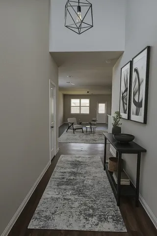 a large room with lots of chairs a rug and white walls