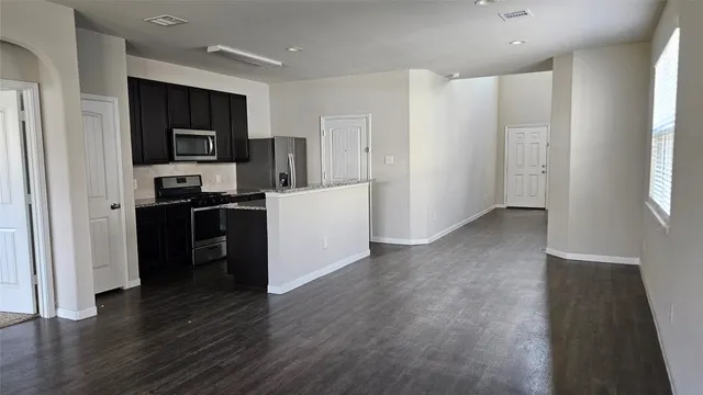 a view of a kitchen cabinets and wooden floor