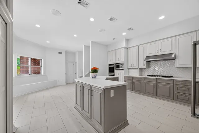 a kitchen with a sink stove and cabinets