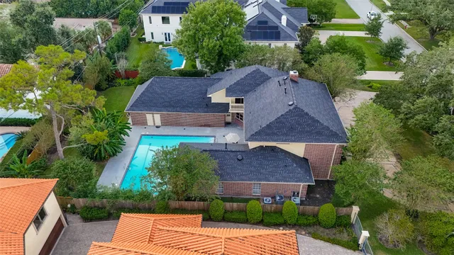 an aerial view of a house with garden space and a street view