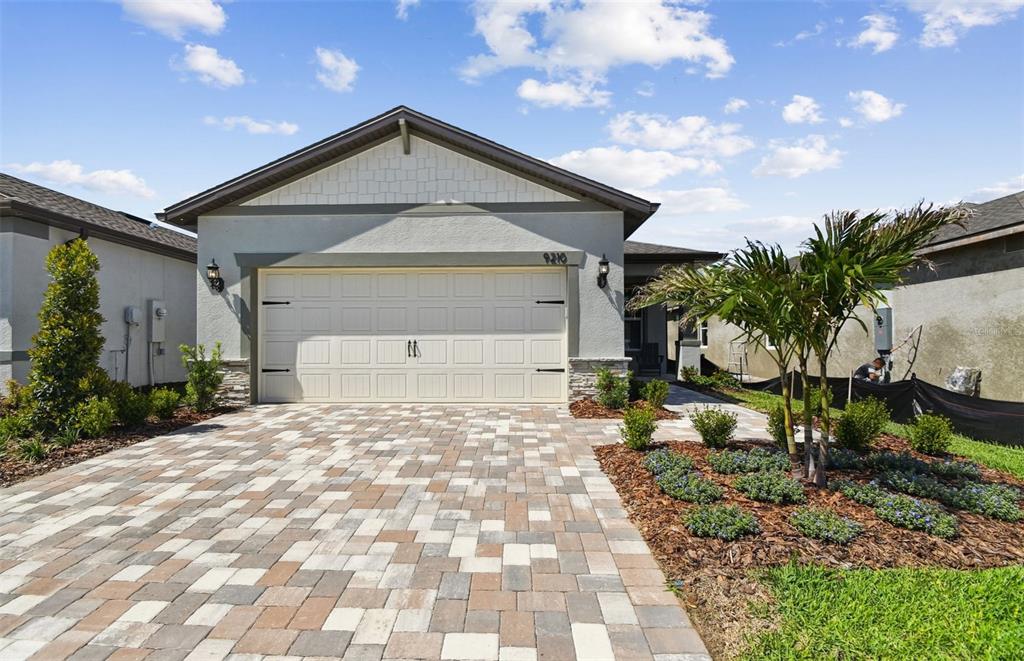 9210 Ballaster Pointe Loop Palmetto, FL 34221 - Photo 1 of 1 a front view of a house with garden