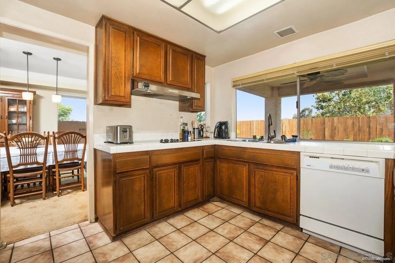 713 Roca Road Chula Vista, CA 91910 - Photo 8 of 26 a kitchen with cabinets and chairs