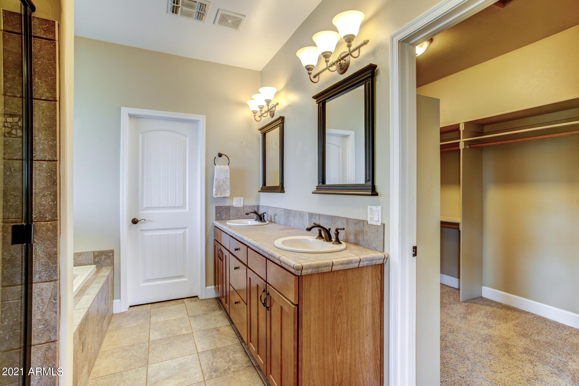 604 North Oak Ridge Road Payson, AZ 85541 - Photo 41 of 55 a bathroom with a sink a mirror and a shower