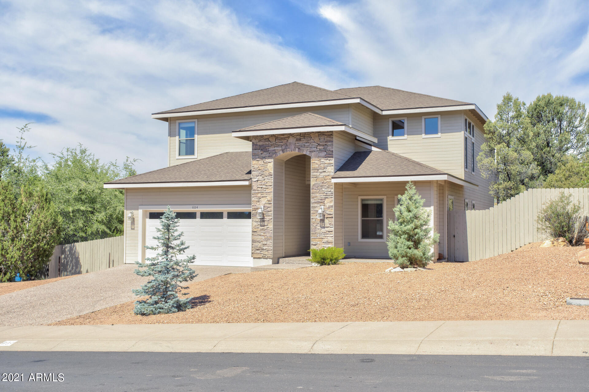 604 North Oak Ridge Road Payson, AZ 85541 - Photo 10 of 55 a front view of a house with a yard and potted plants