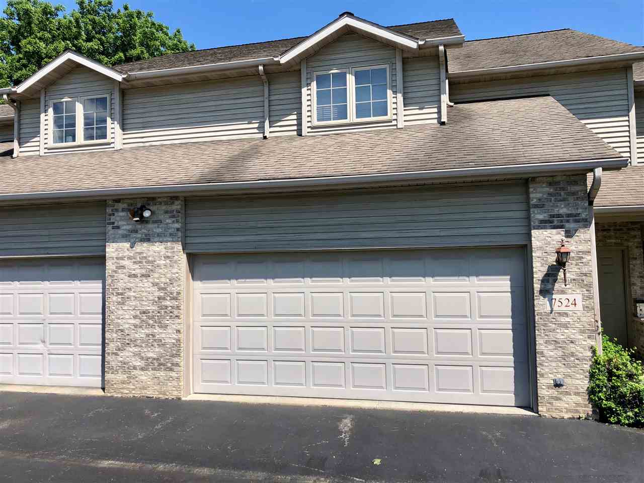 7524 North River Road Byron, IL 61010 - Photo 1 of 21 a front view of a house with a garage