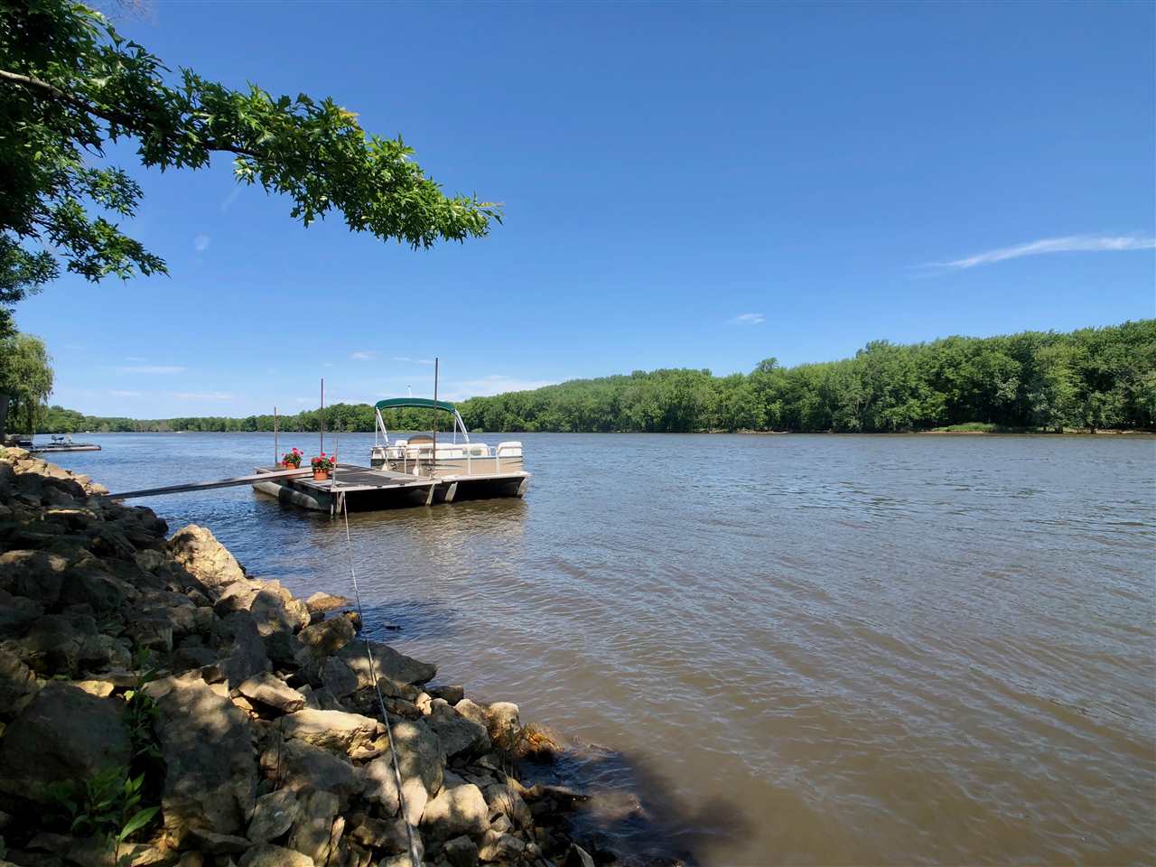 7524 North River Road Byron, IL 61010 - Photo 4 of 21 a view of a lake with boats and trees in the background