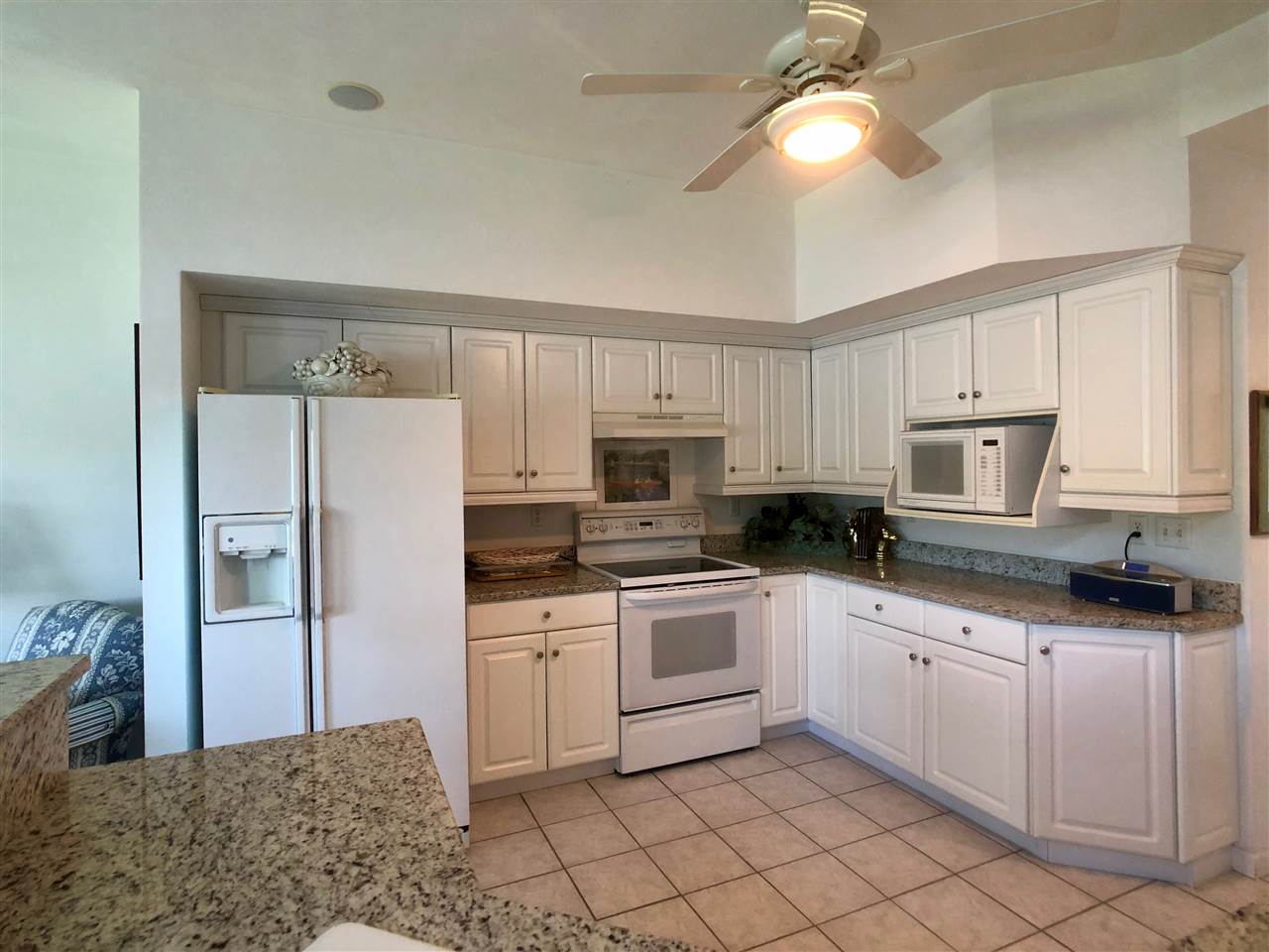 7524 North River Road Byron, IL 61010 - Photo 10 of 21 a kitchen with granite countertop white cabinets white stainless steel appliances with a sink and dishwasher