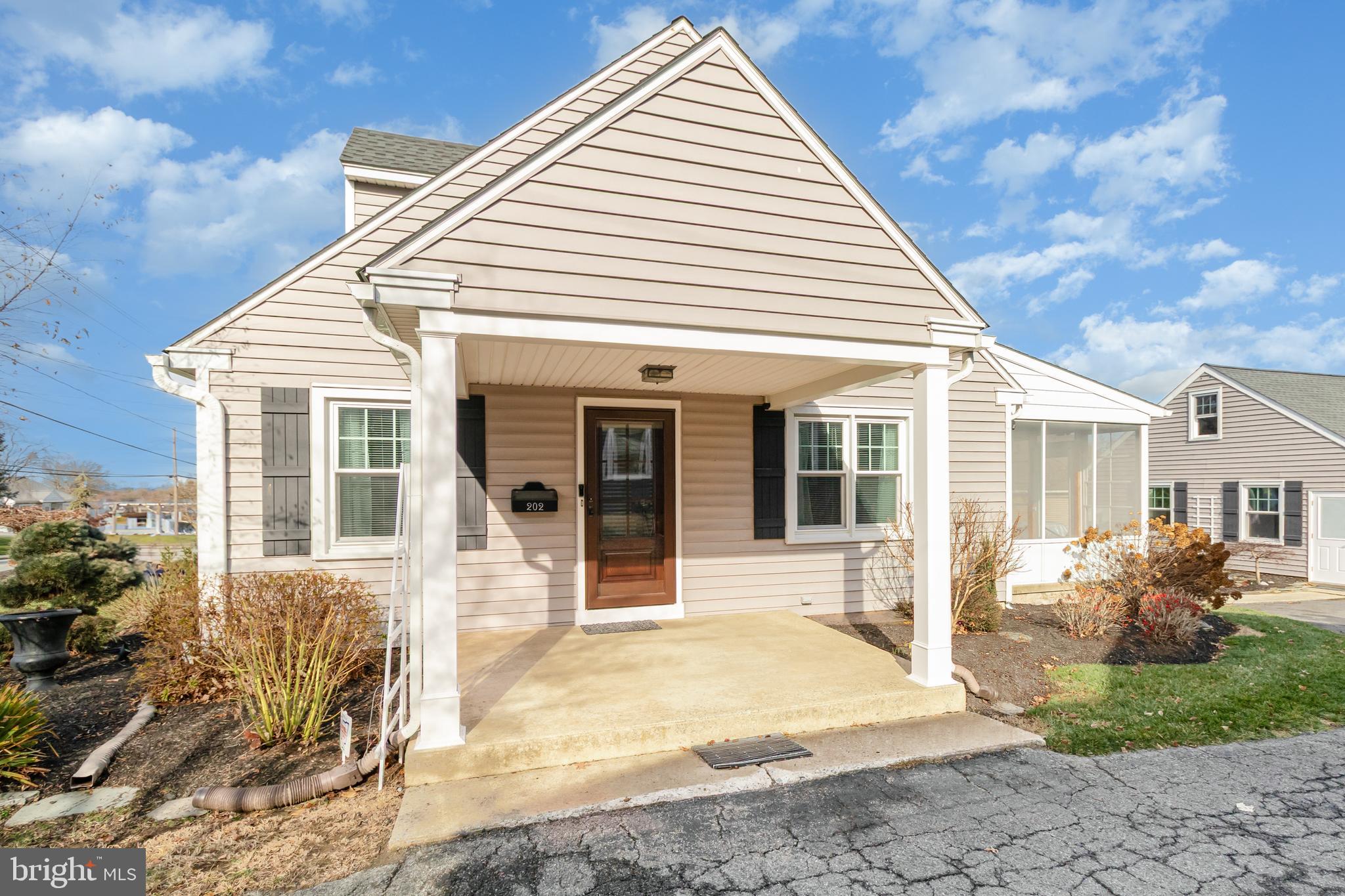 202 North Decatur Street Strasburg, PA 17579 - Photo 20 of 30 a view of a white house with large windows and potted plants