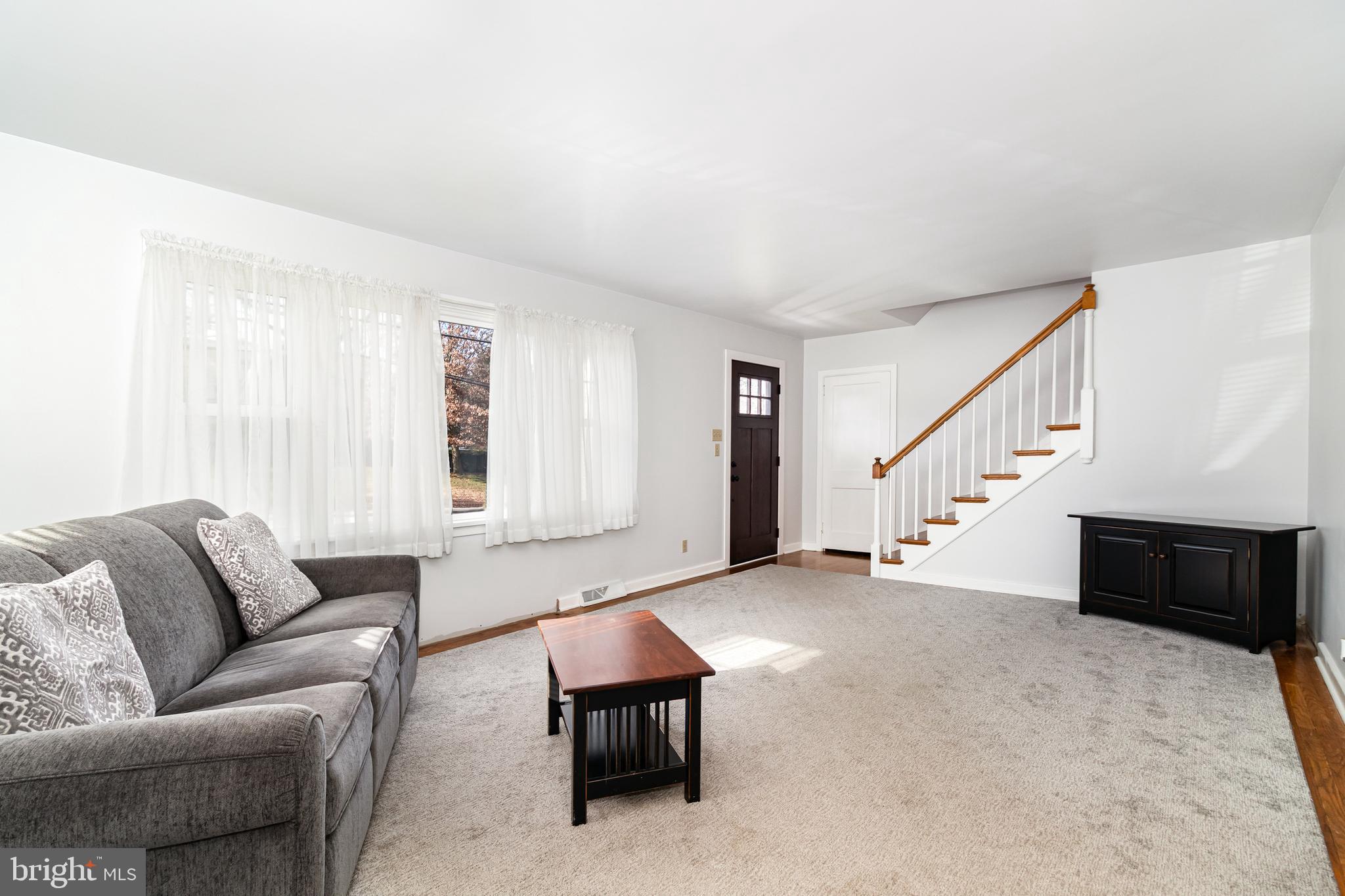 202 North Decatur Street Strasburg, PA 17579 - Photo 4 of 30 a living room with furniture and stairs