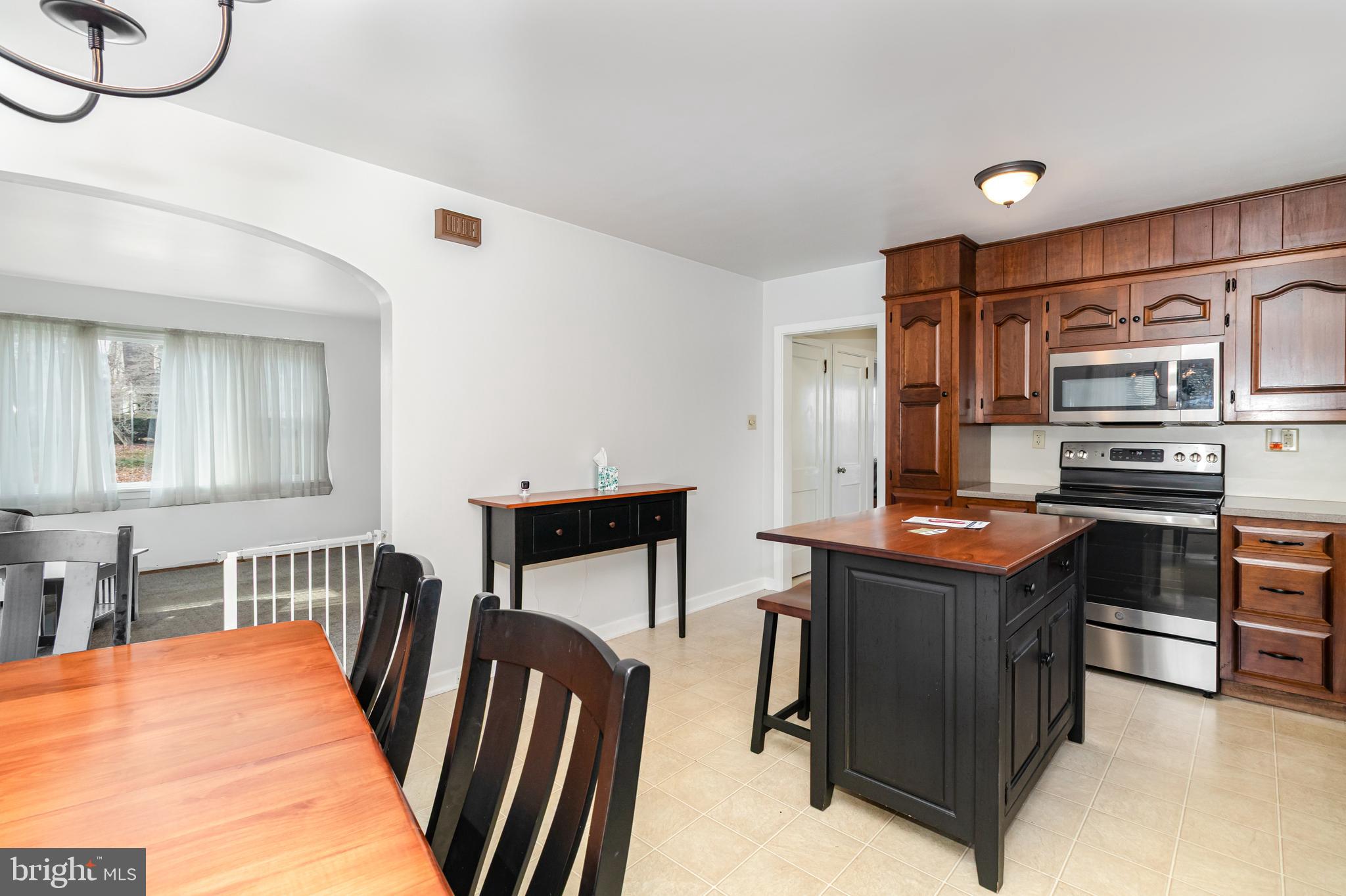 202 North Decatur Street Strasburg, PA 17579 - Photo 8 of 30 a kitchen with stainless steel appliances granite countertop a stove and a refrigerator