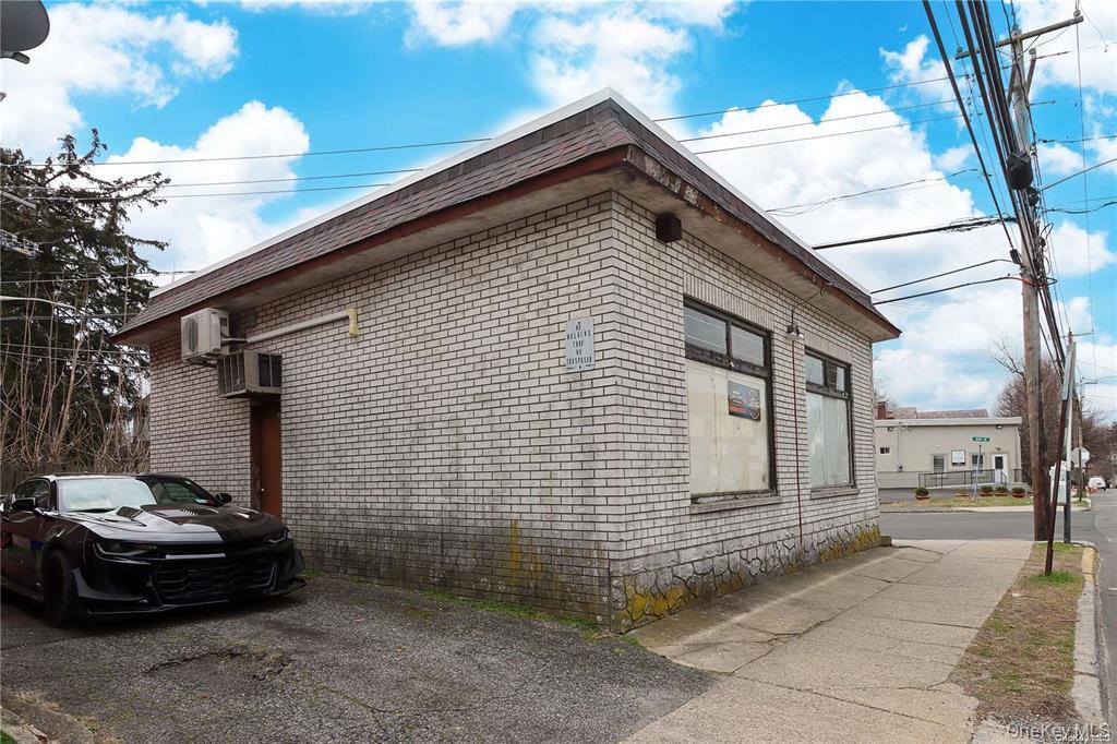 100 Steamboat Road Great Neck, NY 11024 - Photo 4 of 8 a car parked in front of a house