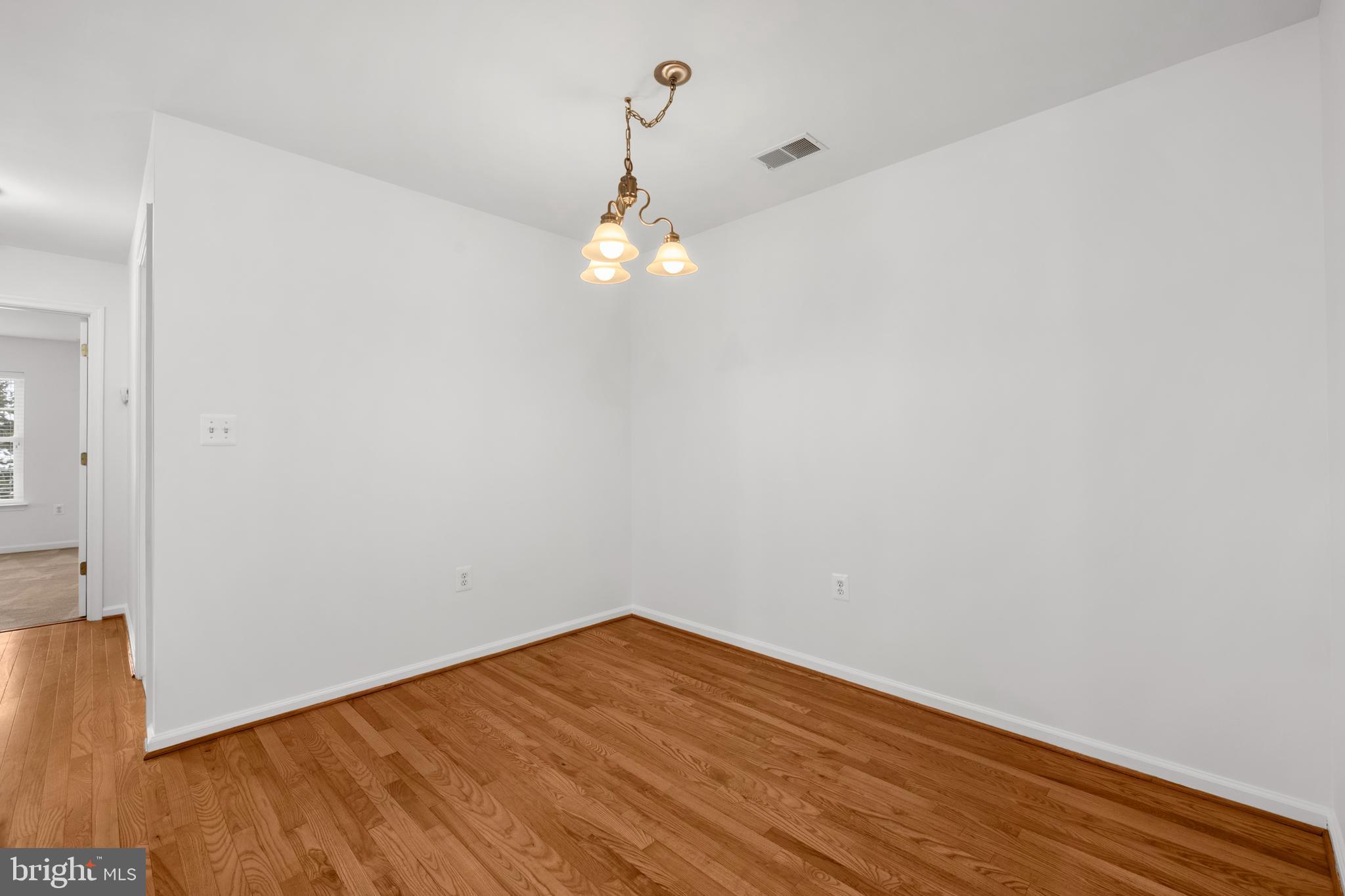 6508 Ridenour Way East, Unit 2A Sykesville, MD 21784 - Photo 7 of 20 a view of empty room with wooden floor