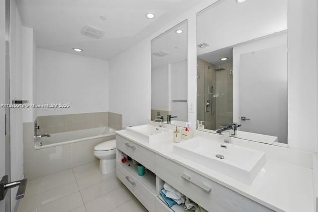 55 Southwest 9th Street, Unit 3506 Miami, FL 33130 - Photo 11 of 17 a bathroom with a tub sink toilet and a mirror