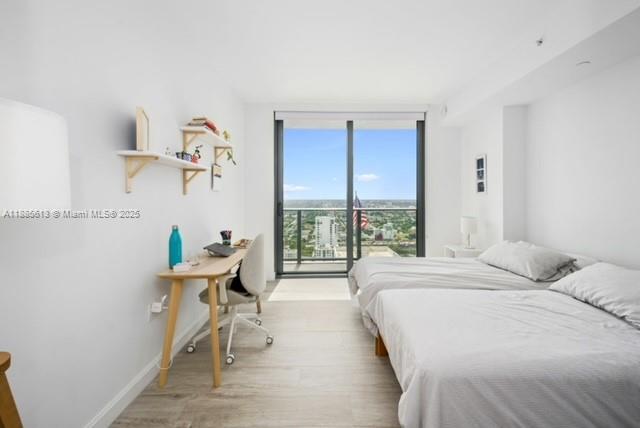 55 Southwest 9th Street, Unit 3506 Miami, FL 33130 - Photo 13 of 17 a bedroom with a bed and a window