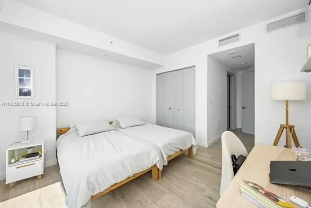 a bedroom with a bed and a table in it