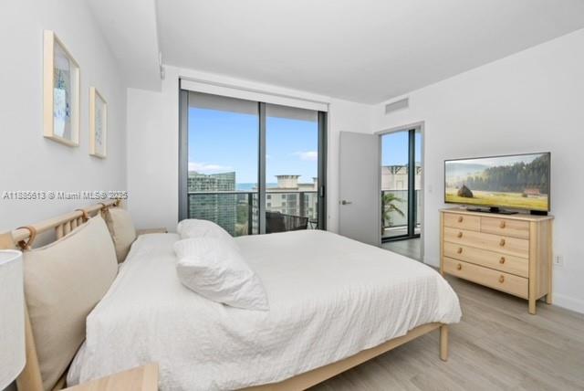 55 Southwest 9th Street, Unit 3506 Miami, FL 33130 - Photo 10 of 17 a bedroom with a bed and a dresser