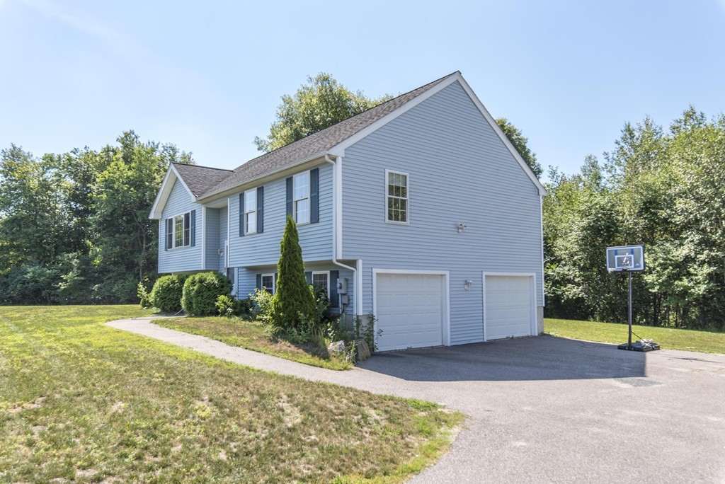12 Hamilton Way Holbrook, MA 02343 - Photo 3 of 13 a front view of a house with a yard and garage