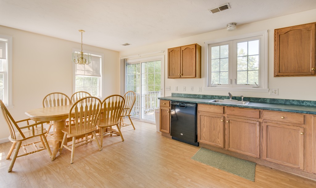 12 Hamilton Way Holbrook, MA 02343 - Photo 6 of 13 a spacious kitchen with stainless steel appliances granite countertop a stove a sink a dining table and chairs