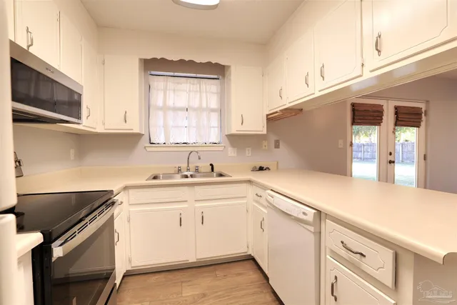 a kitchen with a sink stove and cabinets