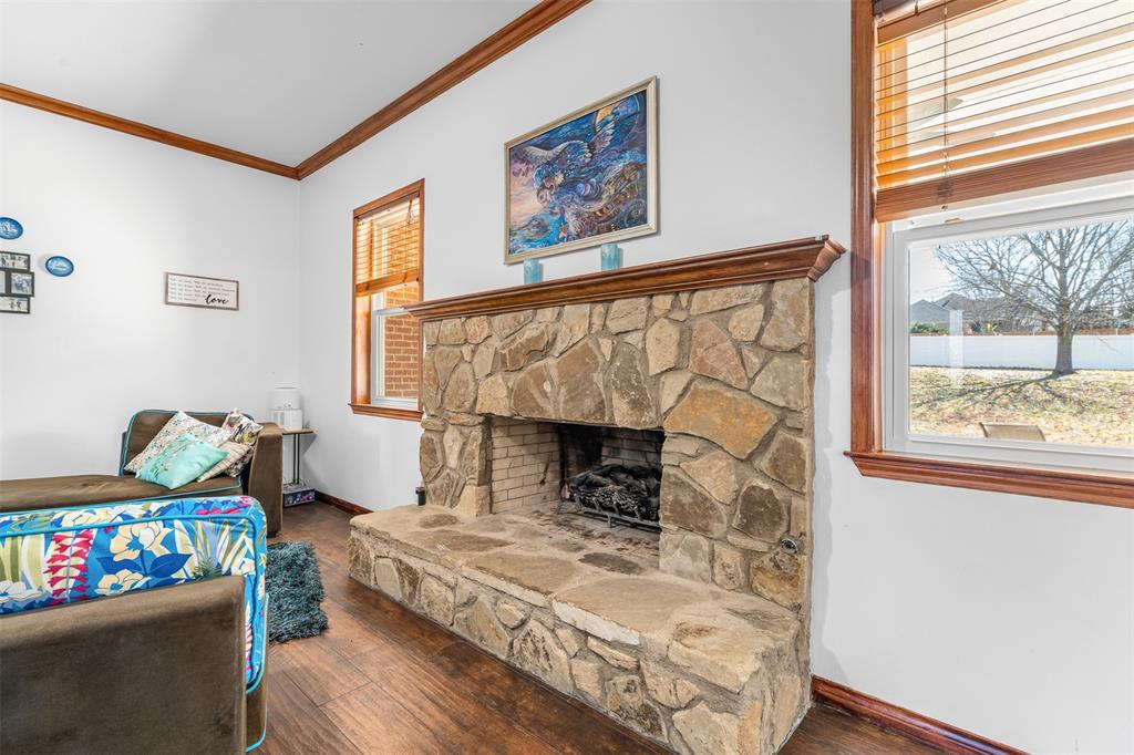 4502 Dexham Road Rowlett, TX 75088 - Photo 12 of 39 a living room with furniture and a fireplace