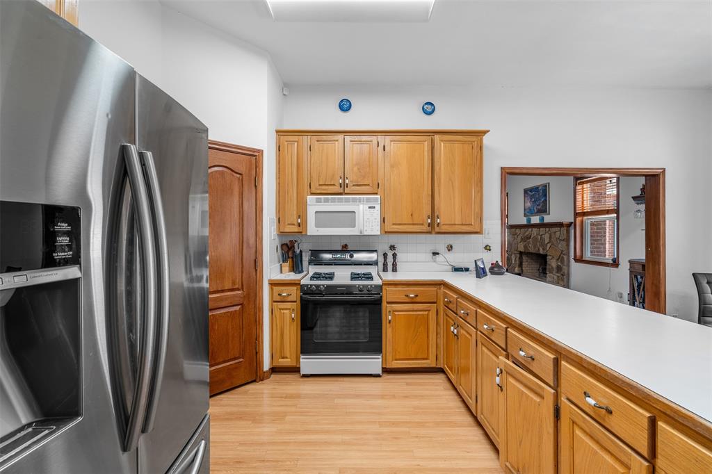 4502 Dexham Road Rowlett, TX 75088 - Photo 16 of 39 a kitchen with stainless steel appliances granite countertop a refrigerator stove and sink