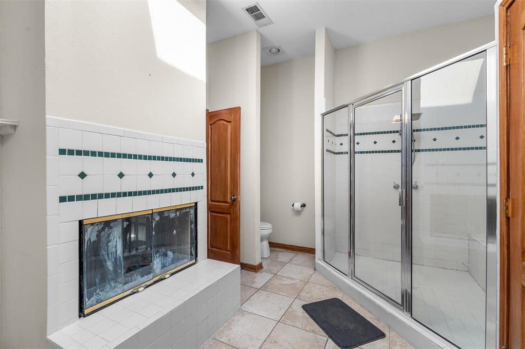 4502 Dexham Road Rowlett, TX 75088 - Photo 22 of 39 a view of an empty room with a fireplace