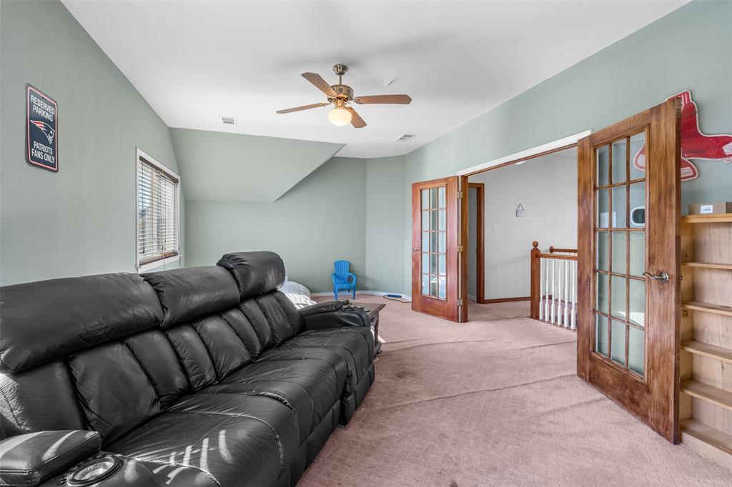 4502 Dexham Road Rowlett, TX 75088 - Photo 25 of 39 a living room with furniture and a ceiling fan