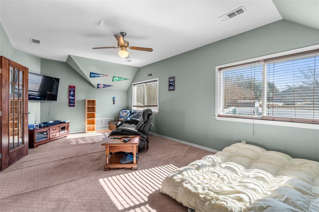 4502 Dexham Road Rowlett, TX 75088 - Photo 27 of 39 a bedroom with furniture and a window