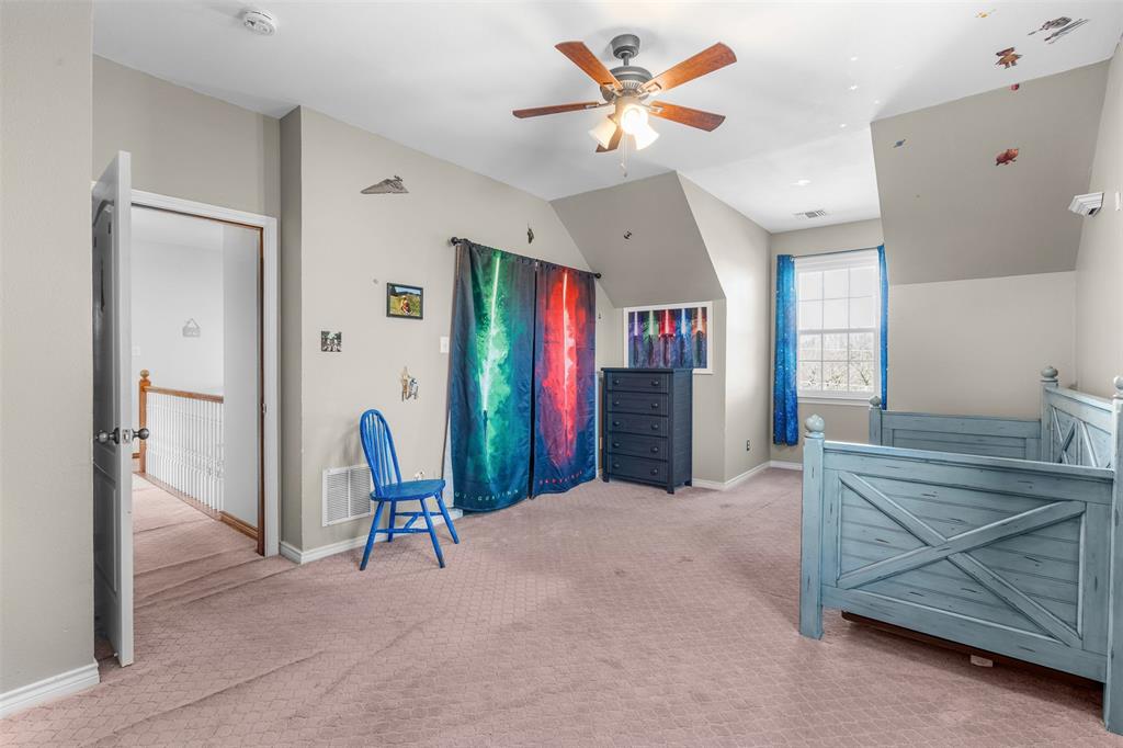 4502 Dexham Road Rowlett, TX 75088 - Photo 29 of 39 a view of a livingroom with furniture and a ceiling fan