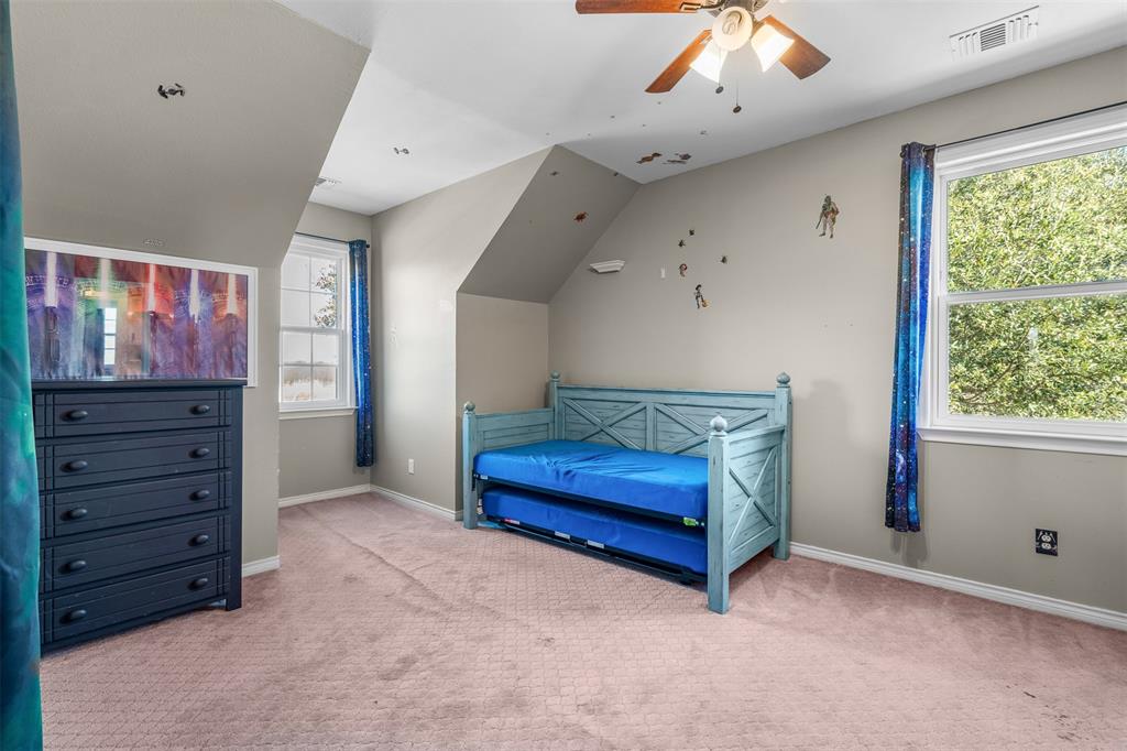 4502 Dexham Road Rowlett, TX 75088 - Photo 30 of 39 a spacious bedroom with a bed and a dresser