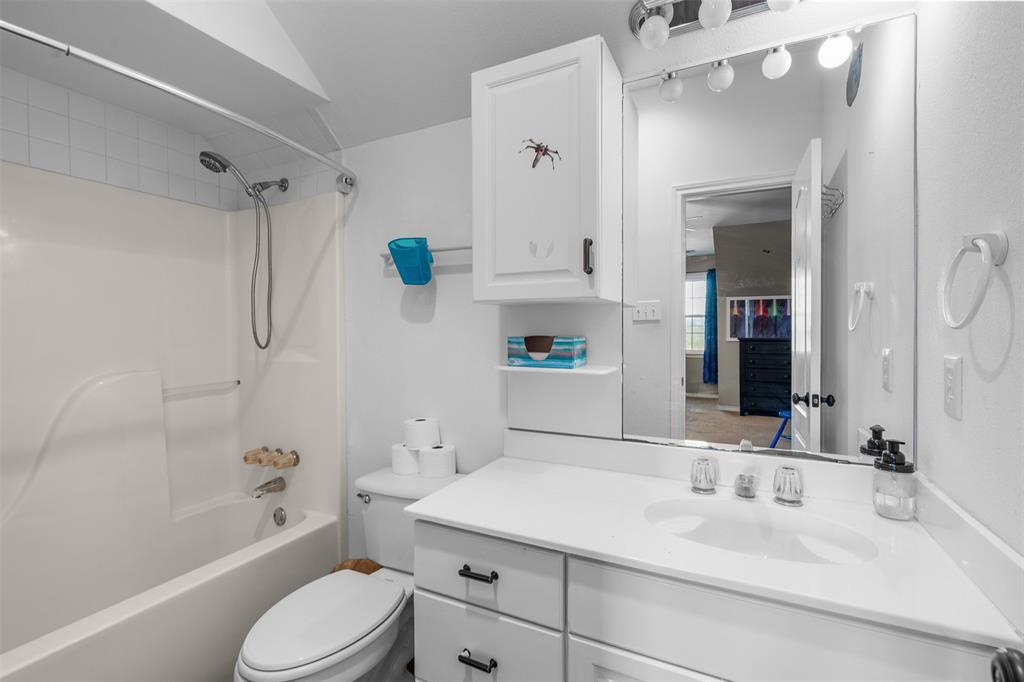 4502 Dexham Road Rowlett, TX 75088 - Photo 31 of 39 a bathroom with a sink a toilet and shower
