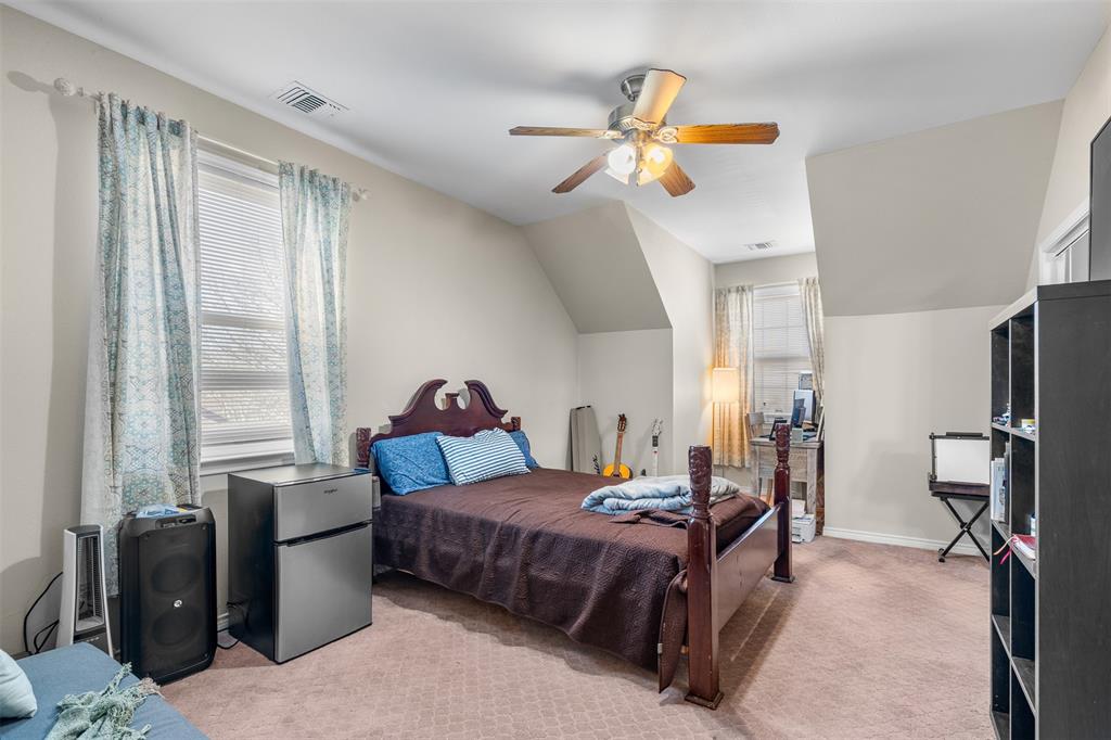 4502 Dexham Road Rowlett, TX 75088 - Photo 32 of 39 a bedroom with a bed and a chandelier