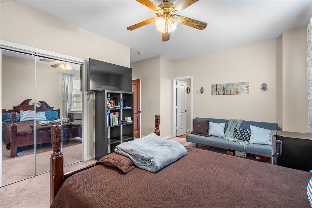 4502 Dexham Road Rowlett, TX 75088 - Photo 33 of 39 a bedroom with a bed and a chandelier