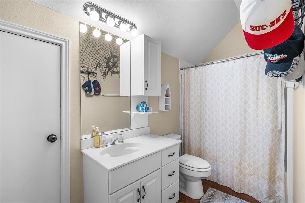 4502 Dexham Road Rowlett, TX 75088 - Photo 35 of 39 a bathroom with a sink toilet and a mirror