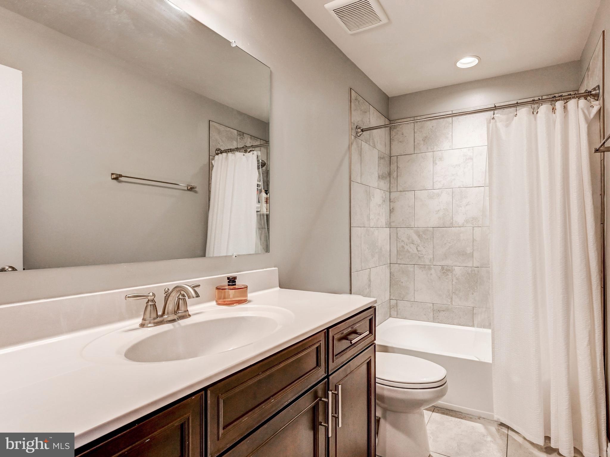 5000 John Buck Avenue Perry Hall, MD 21128 - Photo 33 of 41 a bathroom with a sink toilet a mirror and shower