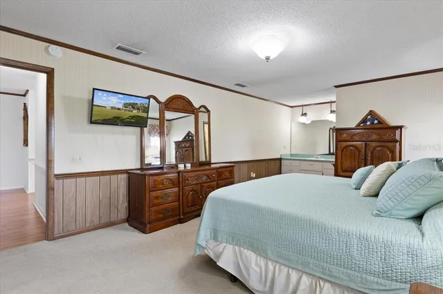 a bedroom with a bed and a dresser