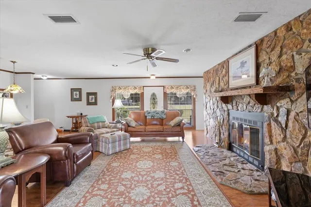 a living room with furniture a fireplace and a table
