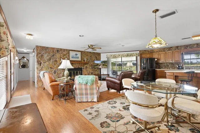 a dining room with furniture and wooden floor