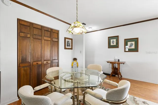 a dining room with furniture and a chandelier